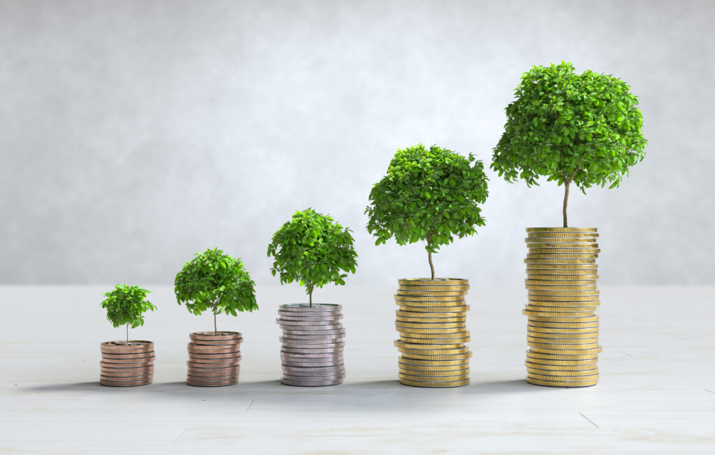 A growing plant sprouting from a pile of coins, symbolizing investment growth.